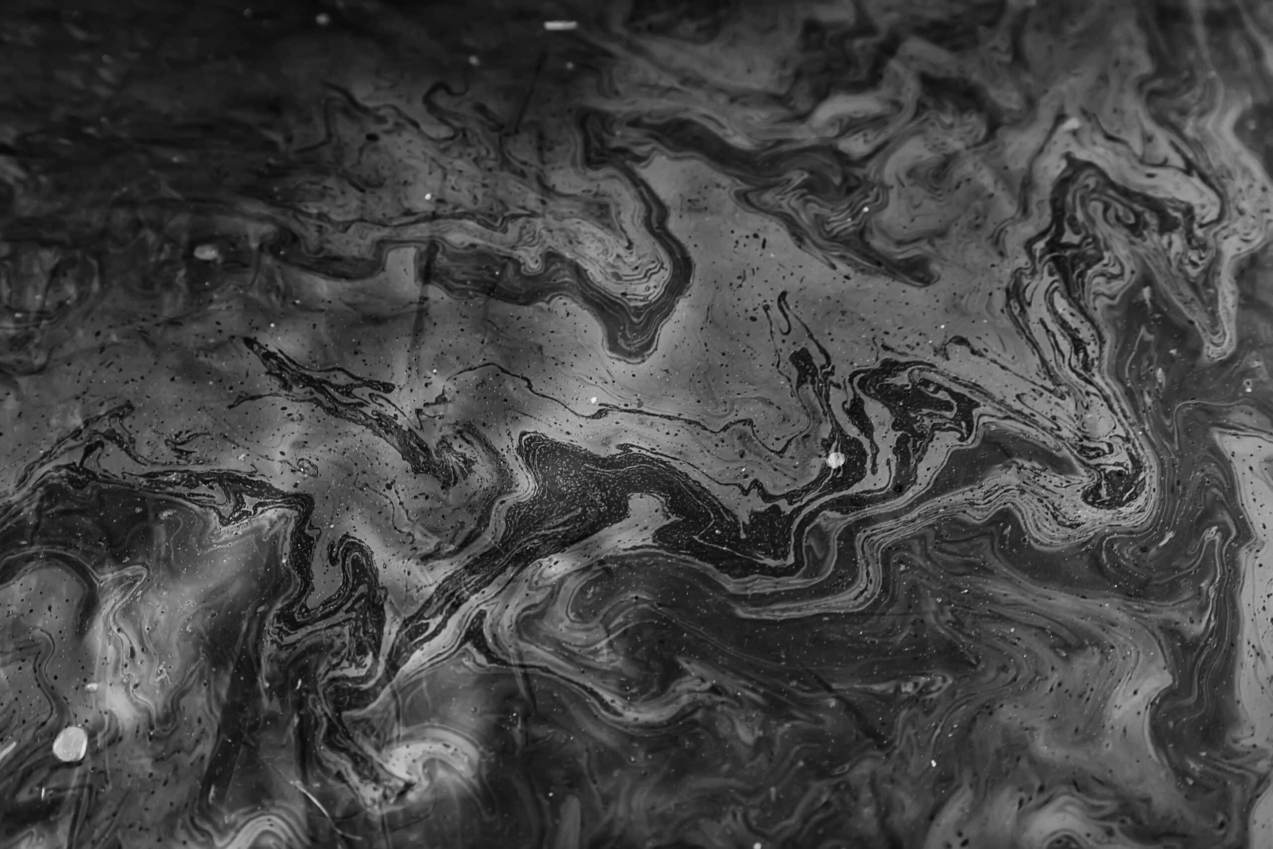 May contain abstract swirls of black and white fluid with speckles.