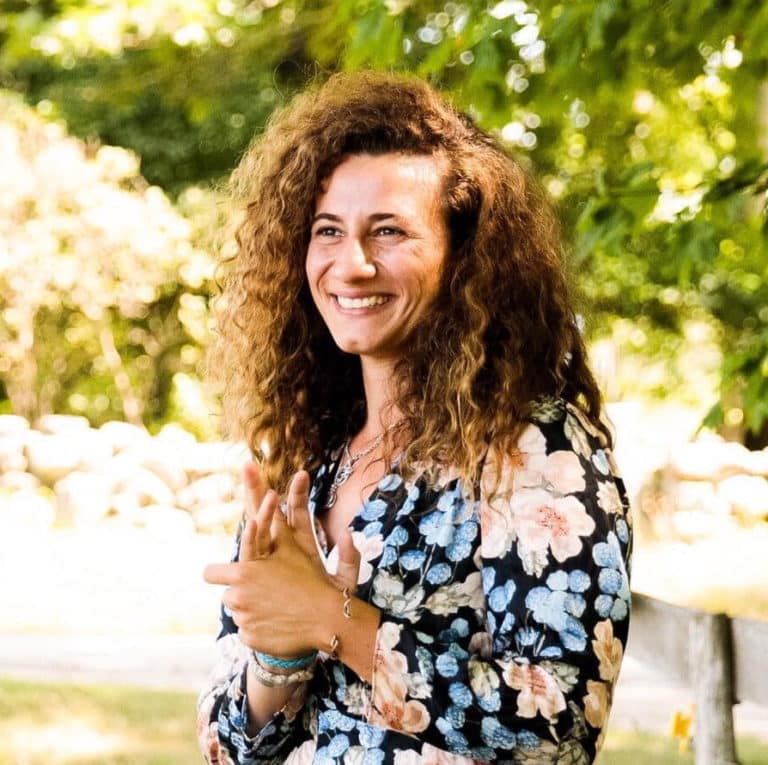 May contain one person with curly hair wearing a floral shirt.
